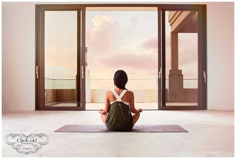 model meditates looking to sunset