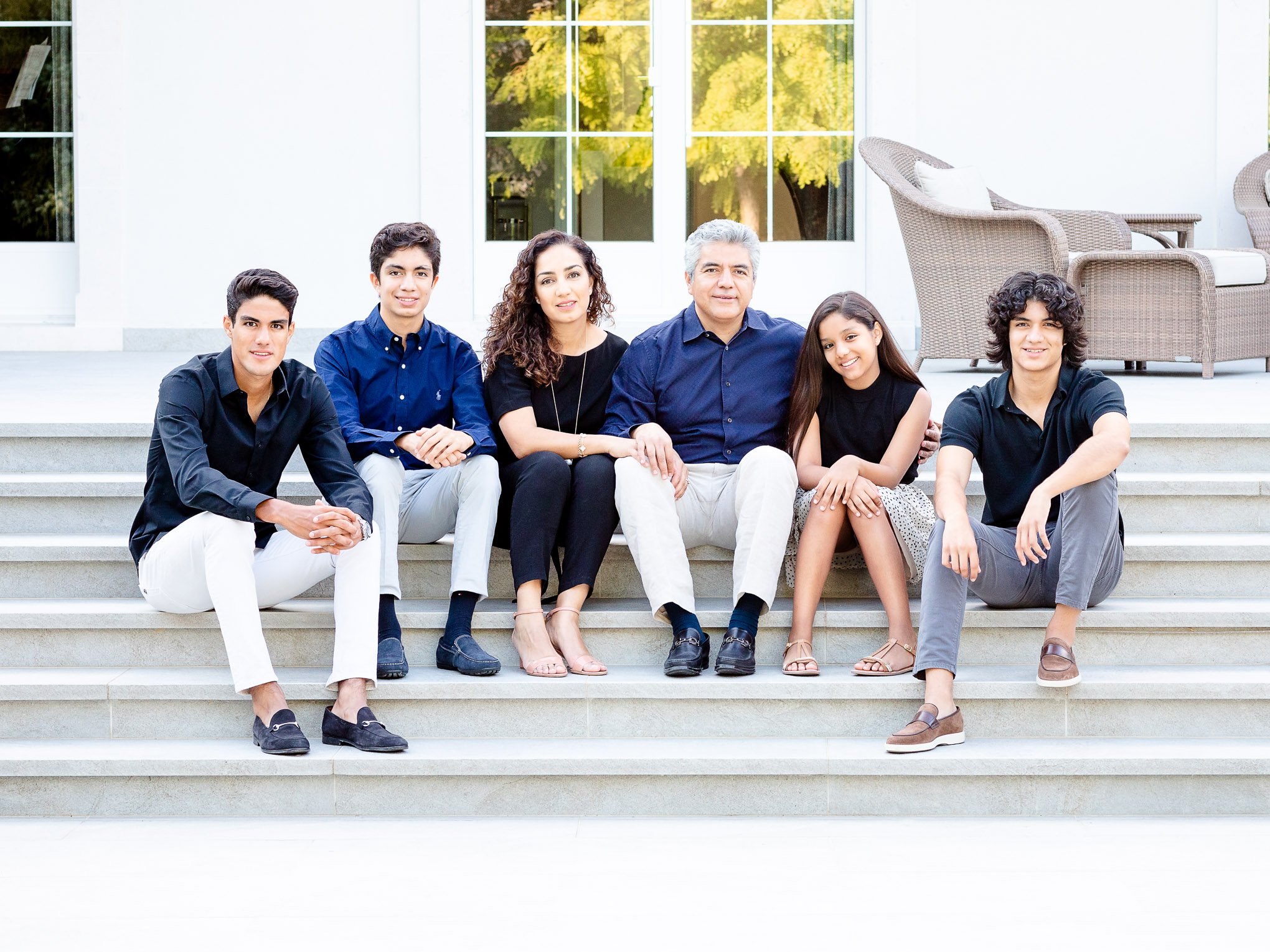 Family sits on steps at home in family photography session